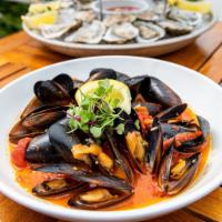 Mussels Giovanni · 1 lb. of fresh mussels steamed and tossed with garlic butter, banana peppers, and plum tomat...