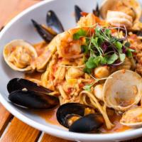 Boardwalk Seafood Pasta · A generous portion of shrimp, scallops, mussels, littlenecks, and chopped clams in a red sau...