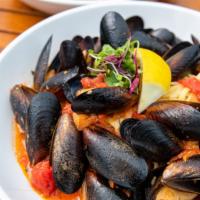 Mussels Giovanni Over Linguini · 1 lb. of fresh mussels steamed and tossed with garlic butter, banana peppers, and plum tomat...