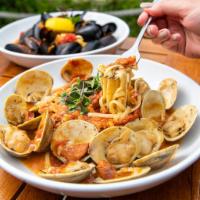 Clam Zuppa Over Linguini · Native littlenecks simmered in a zesty seafood broth with chorizo and marinara sauce.