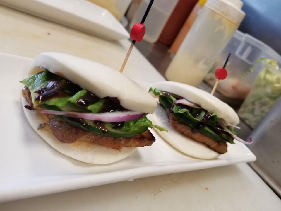 A15. Pork Bun · 2 pieces. Slow cooked pork belly, cucumber and romaine.