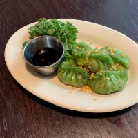 Veggie Dumpling · 4 pieces. Cabbage, carrot and chive serve with spicy soy sauce. Steamed.