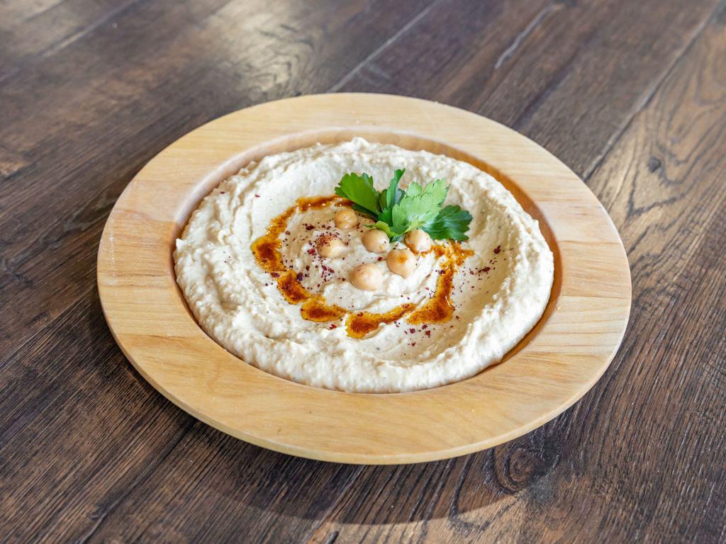 Hummus · Pureed chickpeas with a hint of garlic, tahini, fresh lemon and olive oil.