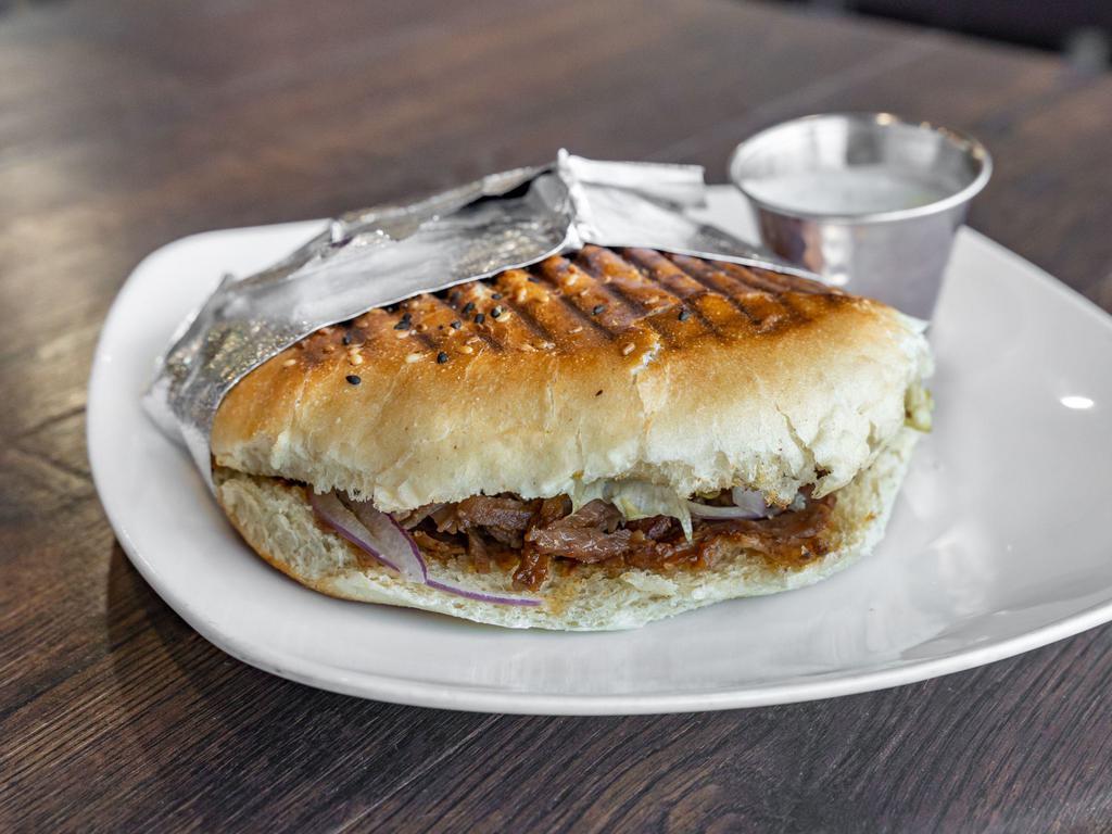 Lamb Gyro Sandwich · Cooked on a spit and wrapped in a pita.