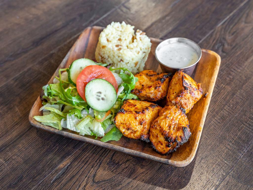 Chicken Shish Kebab · Tenderzed breast of chicken marinated in our secret and grilled on char-grill, served with rice and homemade salad.