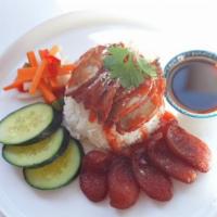 BBQ Roasted Pork Over Rice · BBQ Roasted Pork, Chinese Sausage, Boiled egg, Pickle, Homemade Gravy Topped with sesame see...