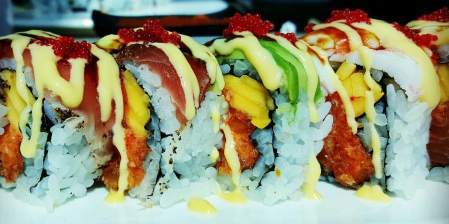 Luna Roll · Spicy crunchy salmon and mango topped with blackened tuna, sweet shrimp, eel, avocado and tobiko with mango sauce.