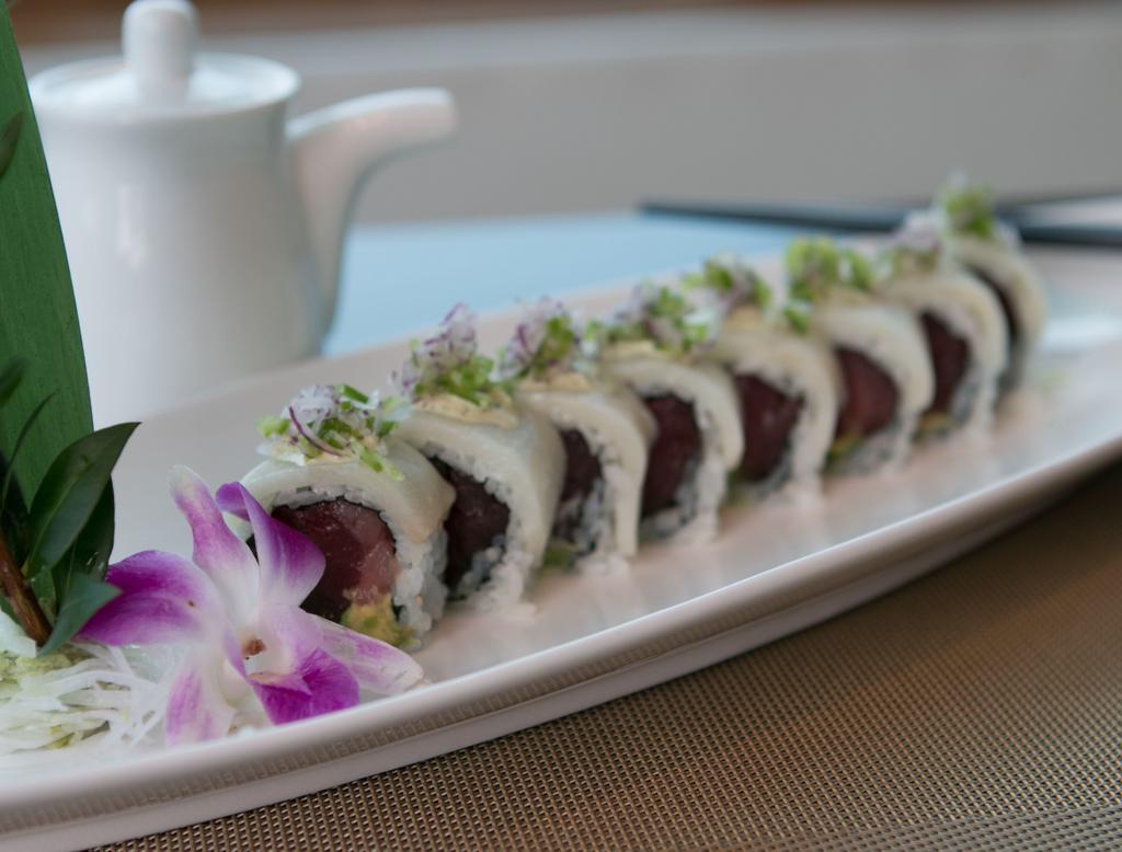 Manhattan Roll · Tuna and avocado topped with yellowtail, jalapeno and onion with jalapeno citrus sauce.
