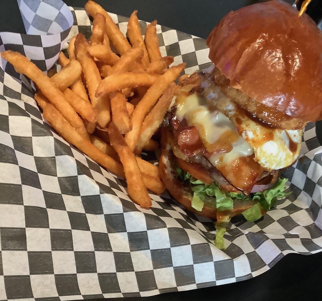 Texas Burger · 1/3lb cheeseburger with bacon, ham and fried egg served with lettuce, tomato, onion ring and BBQ sauce on a brioche bun