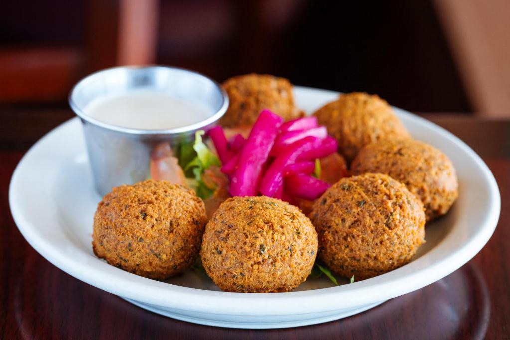 Falafel Appetizer · falafel patties (chickpea/fava bean croquettes)
served with lettuce, tomatoes, pickled turnips 
and tahini sauce. (COMES WITH SOME PITA)
