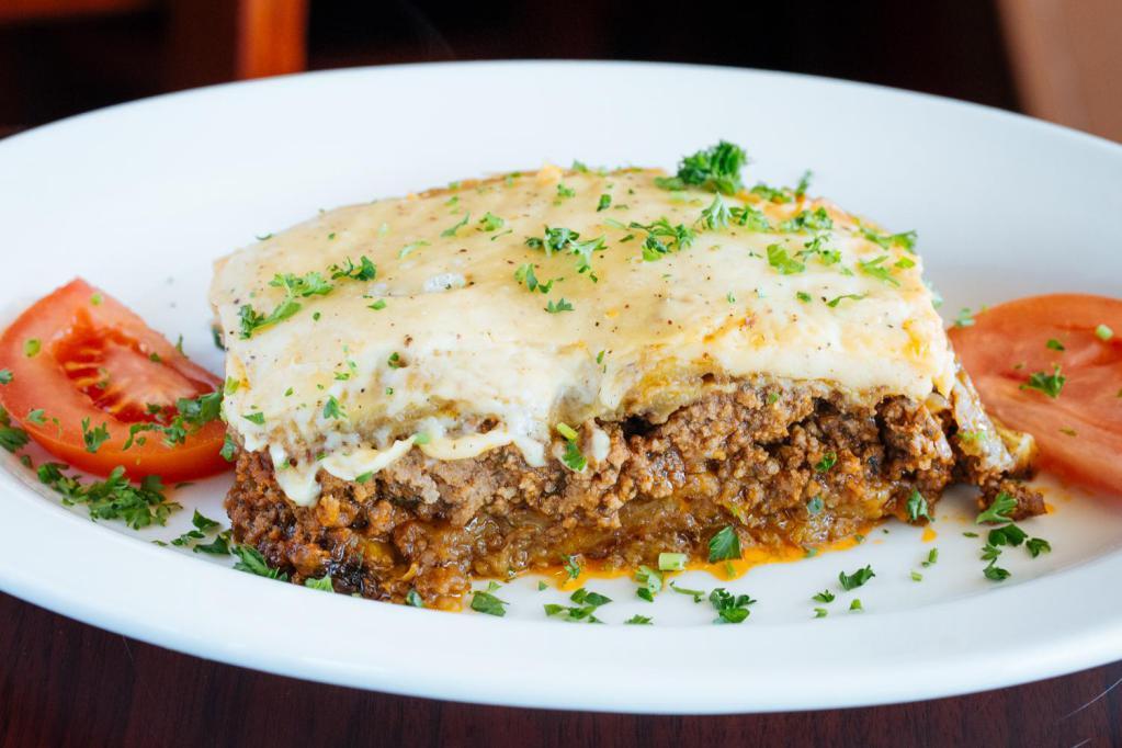 Moussaka · a casserole consisting of sliced eggplant, puréed tomato and ground beef, topped with a rich béchamel sauce. served with rice pilaf.
