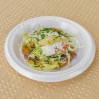 Tostada · Served with beans, avocado, lettuce, tomato, sour cream, cheese, and your choice of meat.