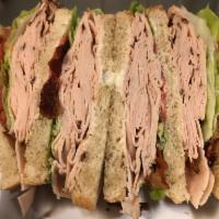 3. Turkey Club  · Served with bacon, lettuce, tomato, and mayo on sliced bread.