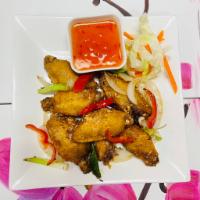 A6. Salt And Pepper Chicken Wings ( 7 ) · Crispy wings tossed with butter, garlic, bell pepper, green and white onions.