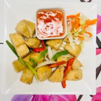 V2. Salt and Pepper Tofu Vegetarian · Crispy tofu tossed with garlic, bell pepper, green and white onions.  100% Vegetarians