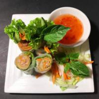 V3. Egg Rolls Wrap Vegetarian · Rice paper wrap with veggie egg rolls, lettuce, basil, pickled daikon, and carrots. Served w...