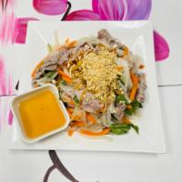 S4. Beef Salad · Medium rare beef mixed with white onions, basil, lettuce, pickled daikon, and carrots in vin...