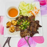 C4. Grilled Beef Short Ribs, Shrimp · Served w/ Jasmine Rice, lettuce, cucumber, pickled daikon and carrots. Topped with green oni...