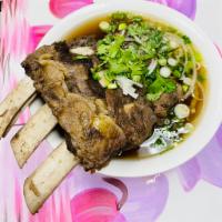 P14. Beef Rib Noodle Soup/ Pho Suon Bo · Made with slow cooked back ribs 