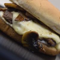 Swiss Mushroom Burger · Melted white cheese, grilled mushrooms,  on a buttered bun.