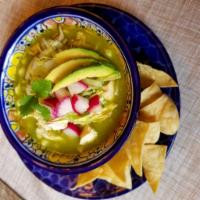 Pozole Verde de Pollo · Pozole soup with chicken, hominy, lettuce, onion, red radish, avocado and lime.