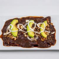 Chicken Mole Poblano Enchiladas · Nixtamal'l Chicken Mole Poblano Enchiladas, with Queso Fresco, Mexican Crema and onions.
Thi...