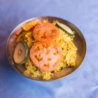 Chicken Biryani · Long grain flavored basmati rice cooked with boneless chicken, eggs, nuts and exotic mild sp...