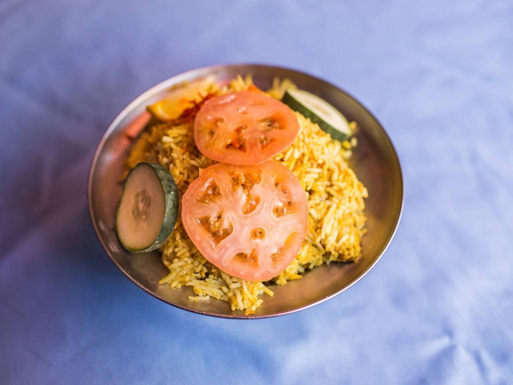 Chicken Biryani · Long grain flavored basmati rice cooked with boneless chicken, eggs, nuts and exotic mild spices.