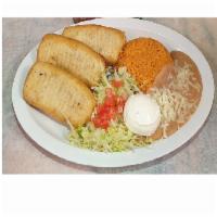 Chimichanga Dinner · 3 flour tortillas fried, filled with your choice of shredded chicken or ground beef and chee...