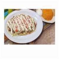 Huarache Dinner · Long fried corn shell masa topped with your choice of meat, beans, lettuce, tomato, sour cre...
