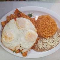 Chilaquiles · 3 scrambled eggs, fried tortilla in special red sauce topped with cheese, onion, tomato and ...
