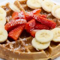 Waffle con Amor · Served with fresh strawberries and banana.