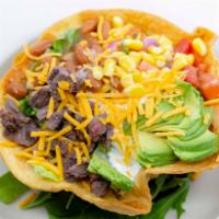 Taco Salad · romaine lettuce, tomato and corn salsa, guacamole, sour cream, beans, and mozzarella cheese ...