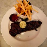 Entrecote Frites · Prime New York strip steak, herbed butter, French fries.