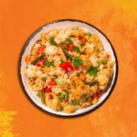 Famous Chicken Fried Rice · Fried rice with chicken, egg, peas, corn, onion, and garlic.