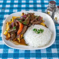 Lomo Saltado · Sauteed sirloin with onions, tomatoes side of white rice, fries, and soy sauce.