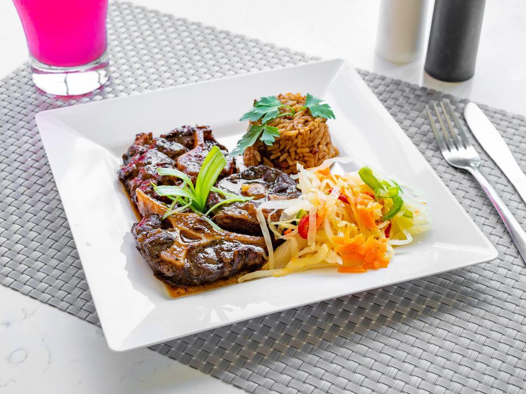 Oxtail Dinner · Oxtail served with Rice and Peas or White Rice, Steamed Cabbage and Plantains