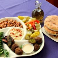 Sampler Platter · Includes salad, pita, hummus, 4 falafel, tabuli, baba ganoush, a slice of eggplant, 1 stuffe...