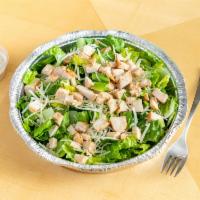 Chicken Caesar Salad · Romaine lettuce, chicken, Parmesan, croutons and Caesar dressing on the side.