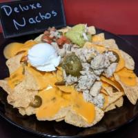 Super Nachos · Choice of steak or chicken, nacho cheese, pico, black olives, jalapeno, sour cream, and guac...