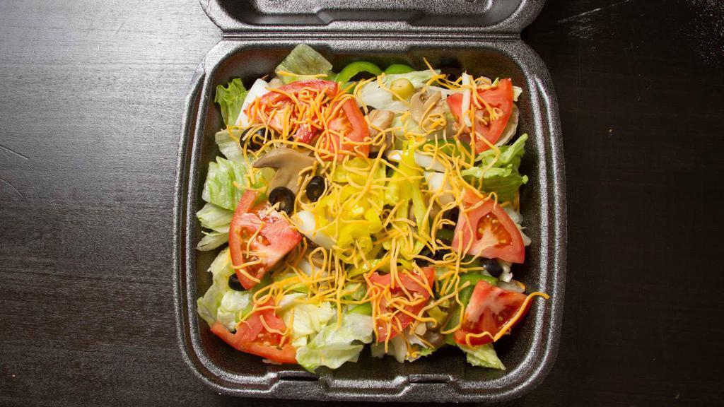 House Salad · Iceberg lettuce, ham, mushrooms, green peppers, onions, green and black olives, tomatoes and cheddar cheese with your choice of dressing
