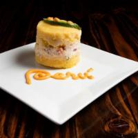 Causa Rellena · 2 layers of mashed potatoes and 1 layer of shredded chicken with mayo and vegetables.