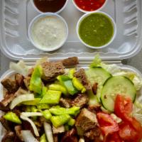 Lamb over Rice · Grilled lamb with sauteed onions and green peppers on top of rice, salad lettuce, tomato, cu...