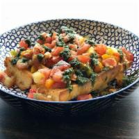 Bruschetta · Tomatoes, garlic, olive oil, balsamic vinegar, and pesto on top of our garlic bread. This co...