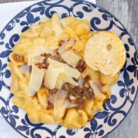 Chili Mac · Shell pasta tossed in house cheese sauce and Nonna’s white bean and beef Italian chili toppe...