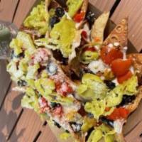 Lasagna Nachos · Deep fried lasagna sheet chips topped with alfredo, black olives, roasted red peppers, peppe...
