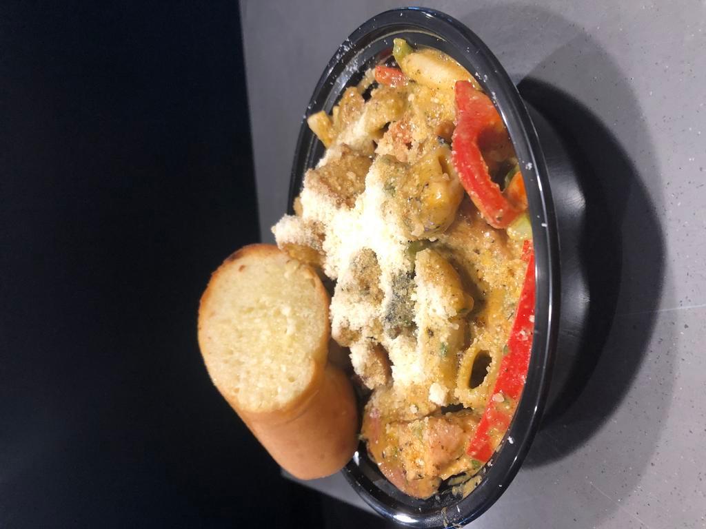 Geaux Queen · Rigatoni tossed with grilled Schwab's andouille sausage, grilled chicken, seasoned and sautéed shrimp, sautéed bell peppers, garlic in a creamy cajun pesto sauce topped with grated parmesan. 