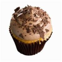 Vanilla and Chocolate Cupcake · A vanilla cupcake topped with chocolate buttercream and chocolate shavings.