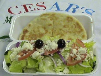 #68. Small Greek Salad and Pita · Lettuce, tomato, onion, cucumber, feta, Kalamata olives with Cesar’s Greek dressing.