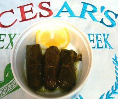 #82. Grape Leaves · Cesar’s recipe, 3 pieces, with a slice of lemon.